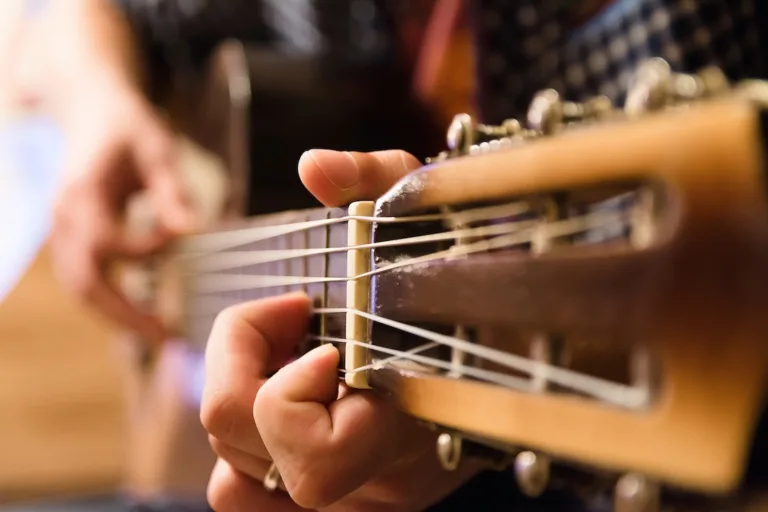 Young guy playing the classical guitar