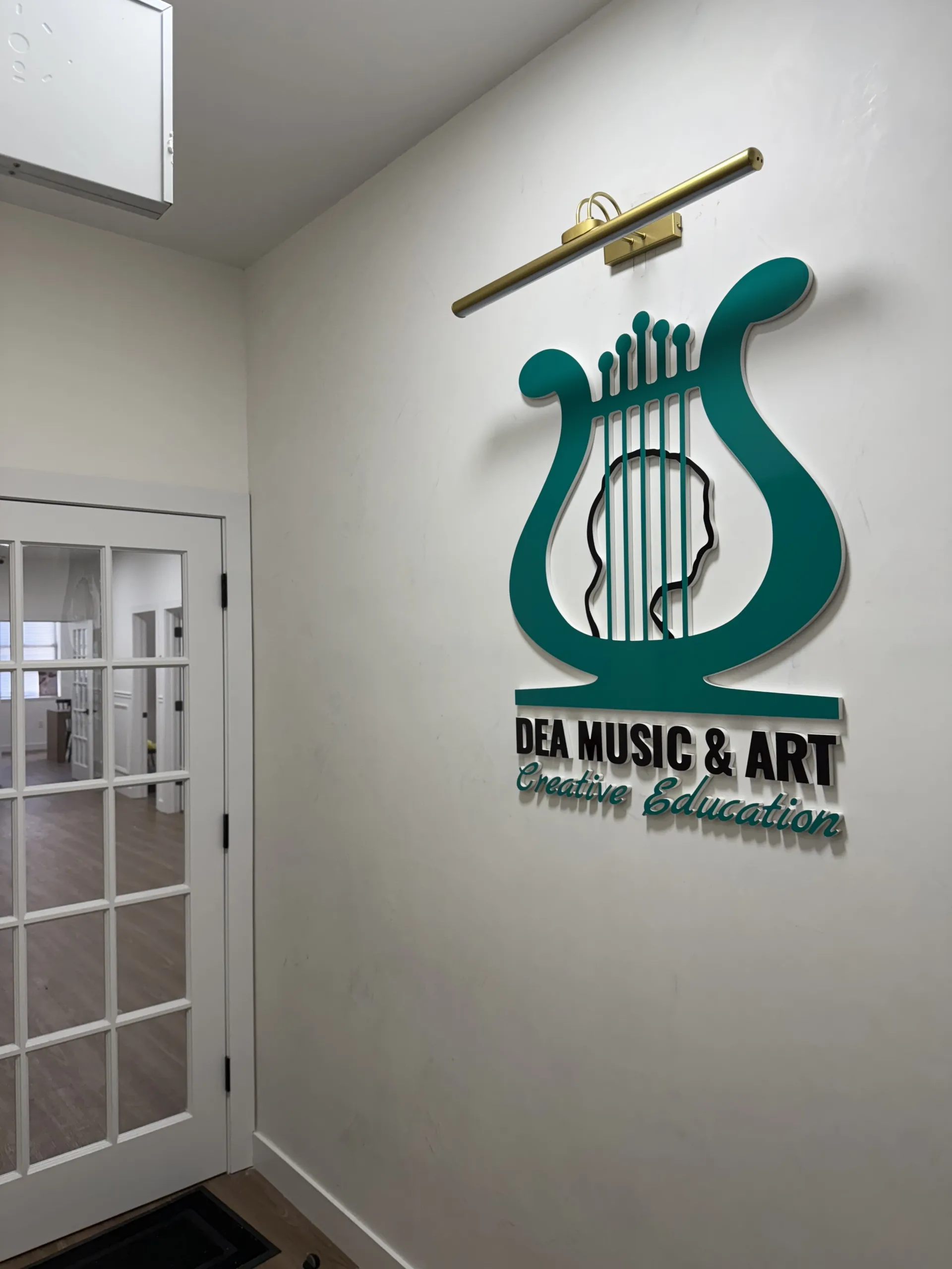 DEA Music and Art Manhattan logo wall